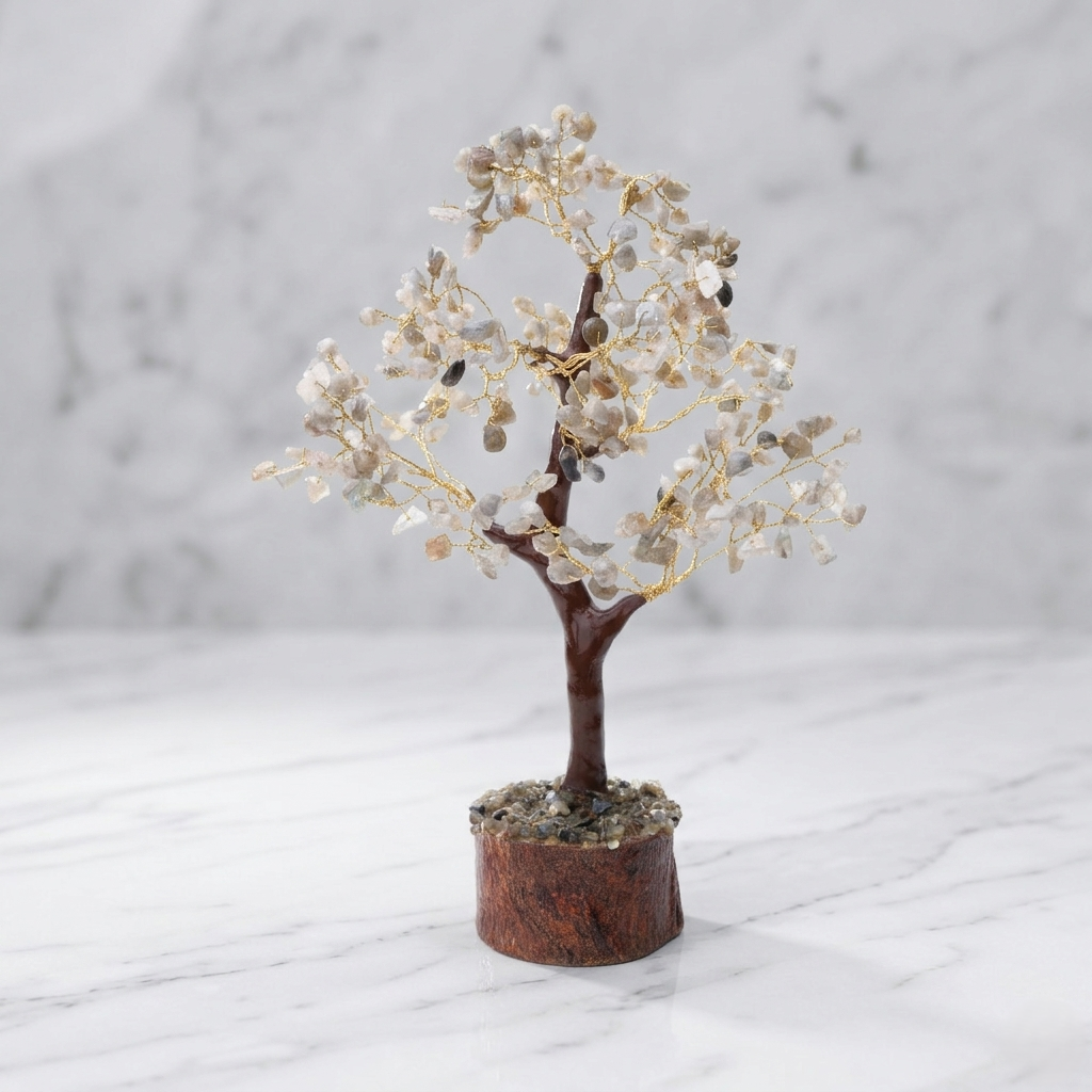 White crystal stone tree on wooden base styled with books and gold lamp