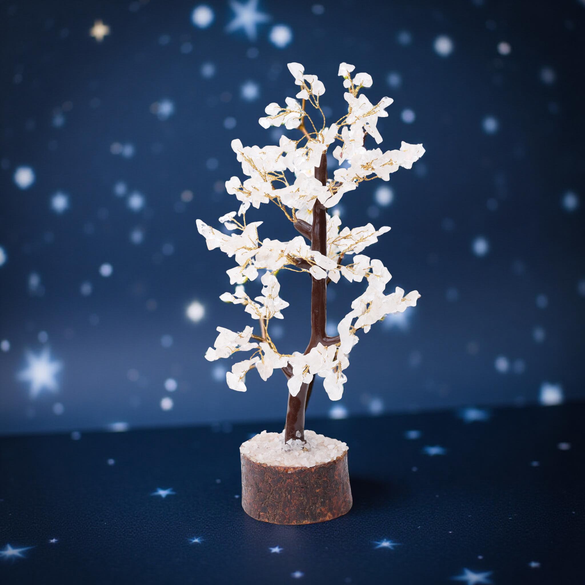 AstroViz white moonstone gemstone chip blossom tree with looping trunk on dark bark wood slice base displayed on blue star-field background--3