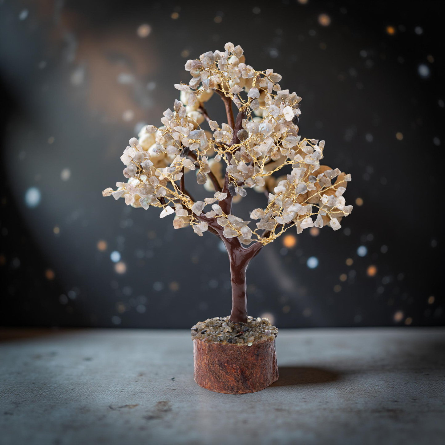 Clear quartz wish tree with gold wire branches on natural wood log base
