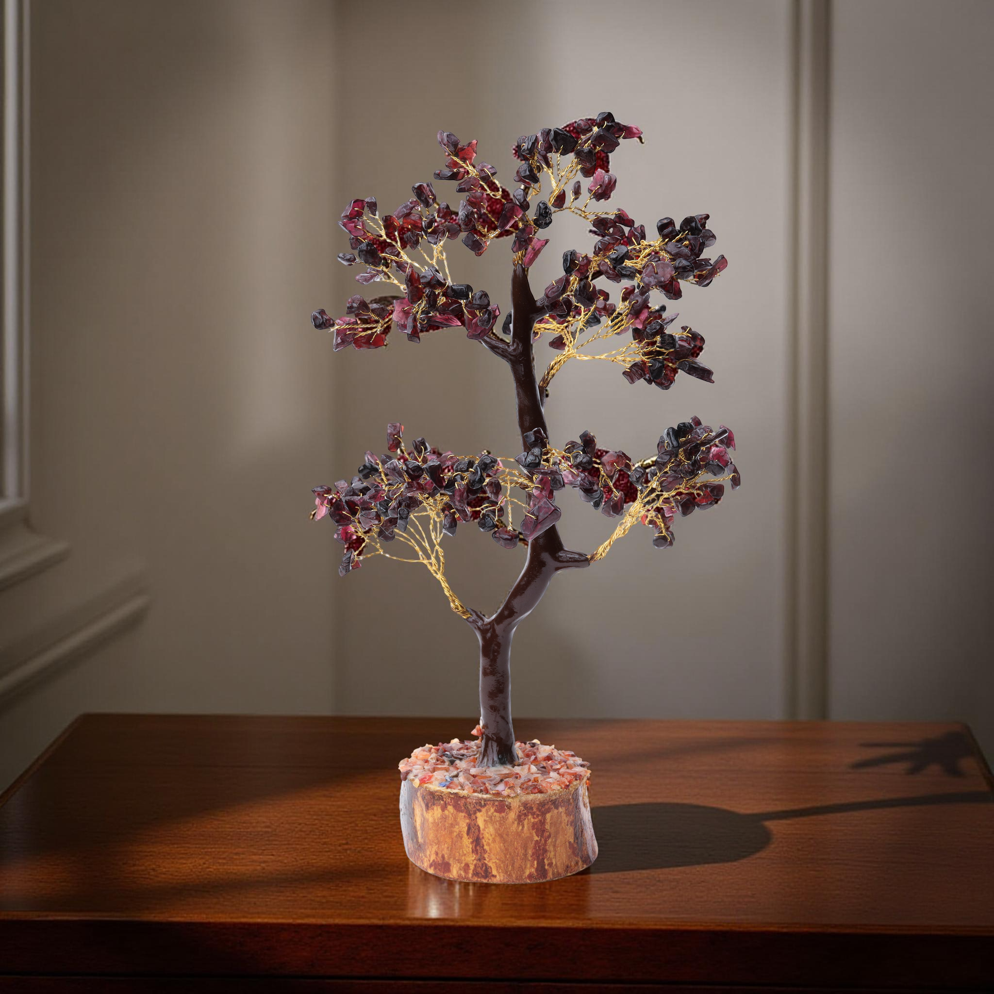AstroViz handcrafted garnet chip two-tier bonsai tree on warm golden wood slice base displayed on wooden tabletop, neutral interior--4