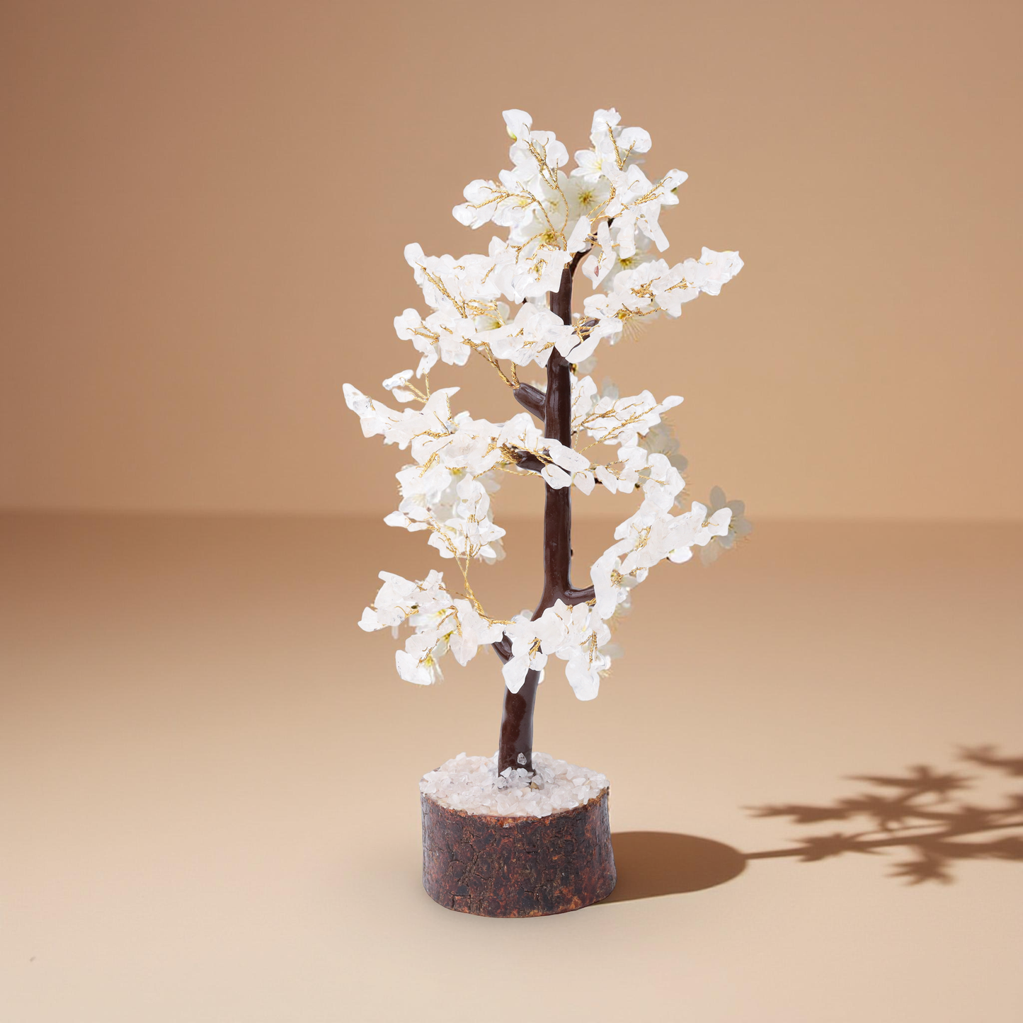 AstroViz white moonstone blossom tree with floral-rosette engraved chip details and gold wire open branches on coarse crystal chip dark bark wood base warm beige background