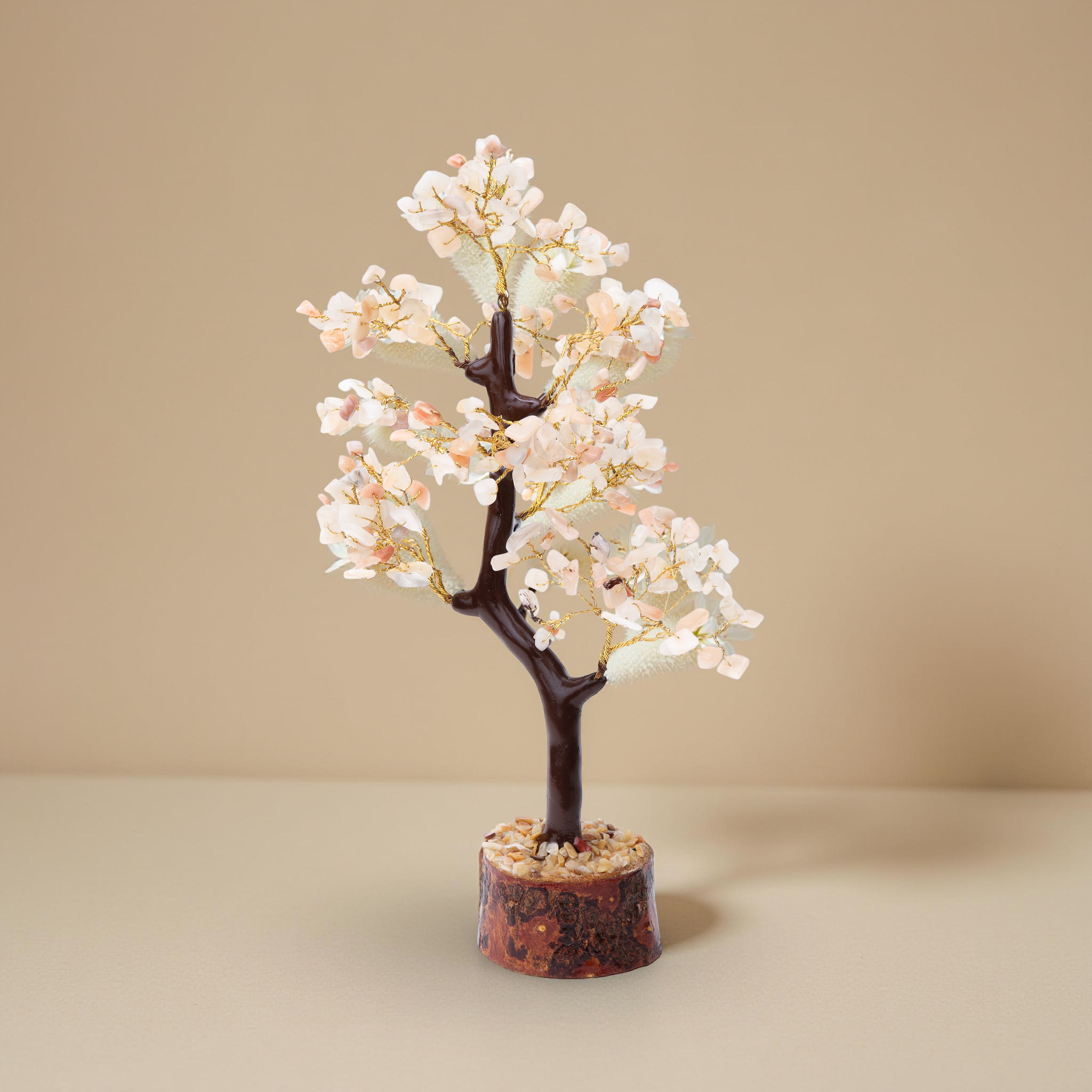 AstroViz rose quartz stone chip decorative tree on natural wood slice base displayed on marble pedestal, grey background--4