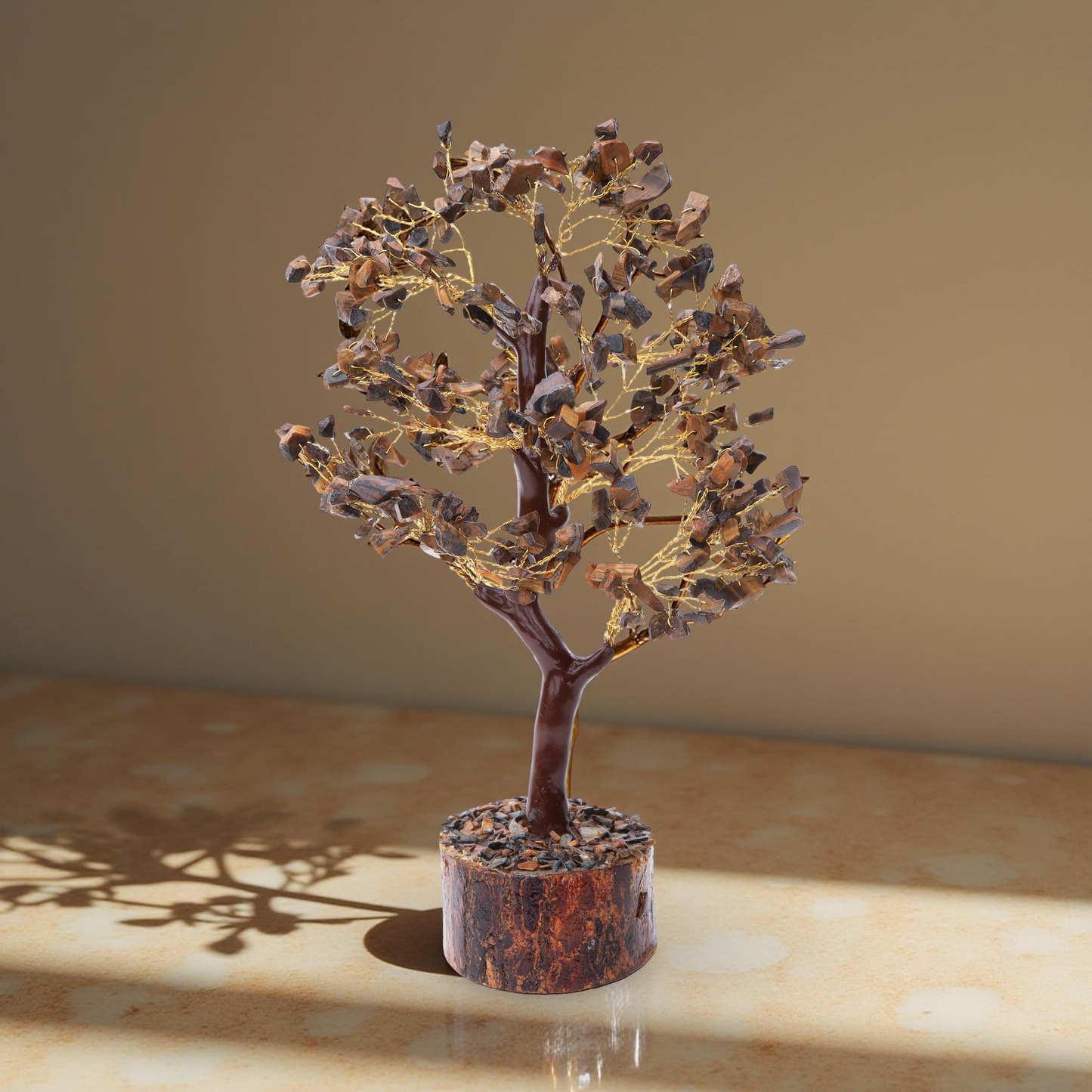 AstroViz Tiger's Eye crystal tree casting a shadow on a marble surface.