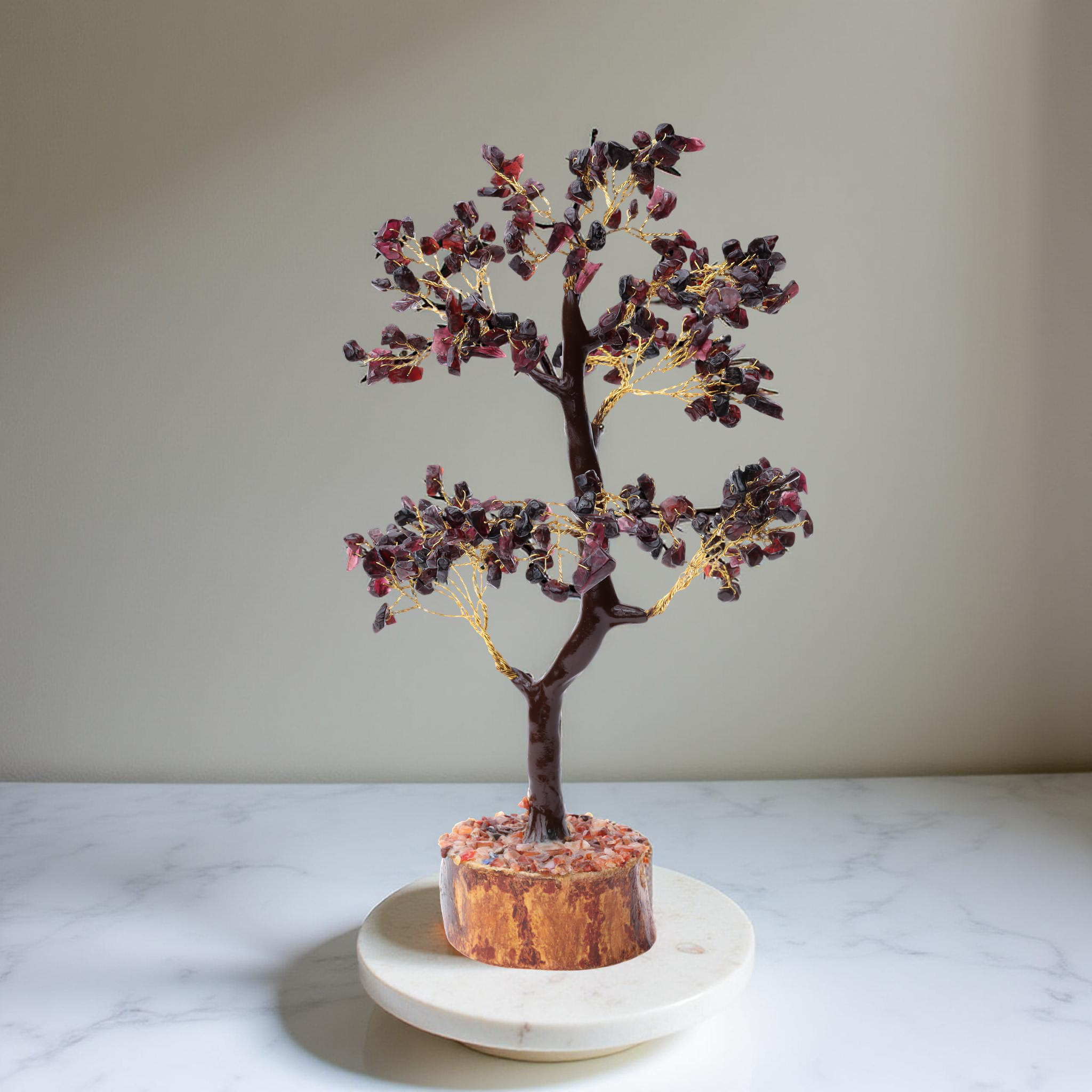 AstroViz garnet gemstone chip bonsai tree on golden-brown wood slice base displayed on white marble serving tray, neutral wall background--5