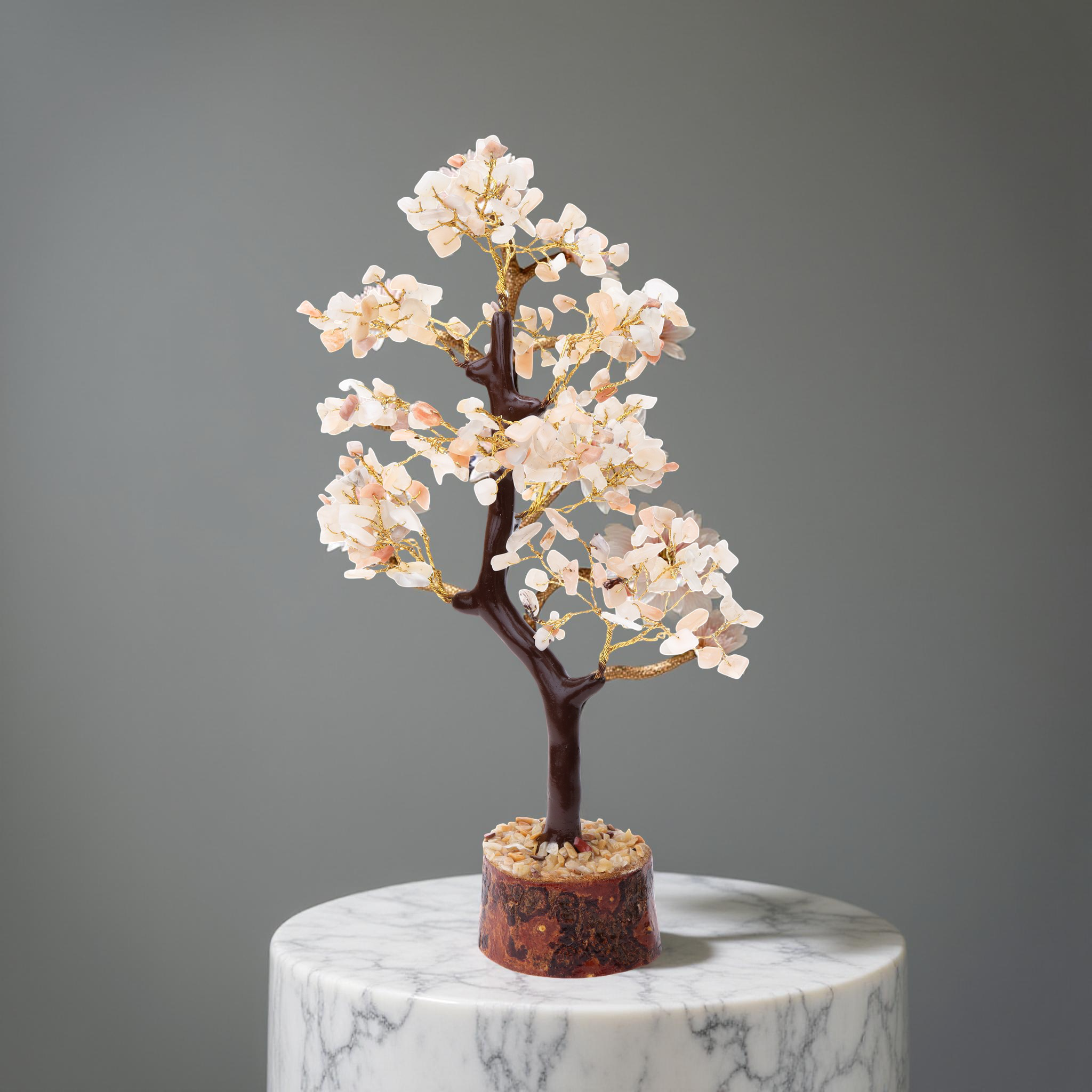 AstroViz rose quartz stone chip decorative tree on natural wood slice base displayed on marble pedestal, grey background
--5