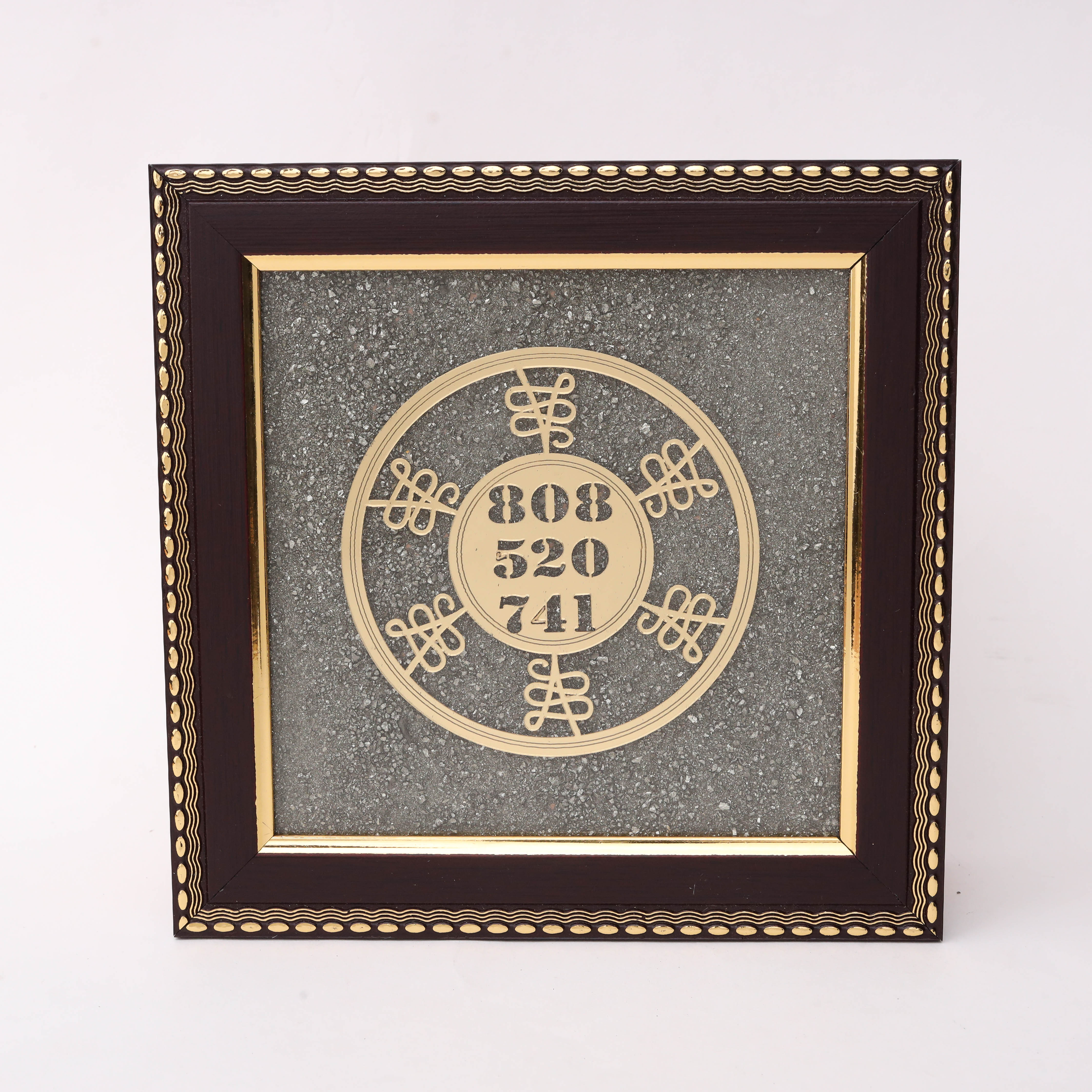 Gold laser-cut Solfeggio Frequency numbers 808 520 741 in circular double-ring design with ornate knot motifs on charcoal stone texture background in dark wood decorative frame--1