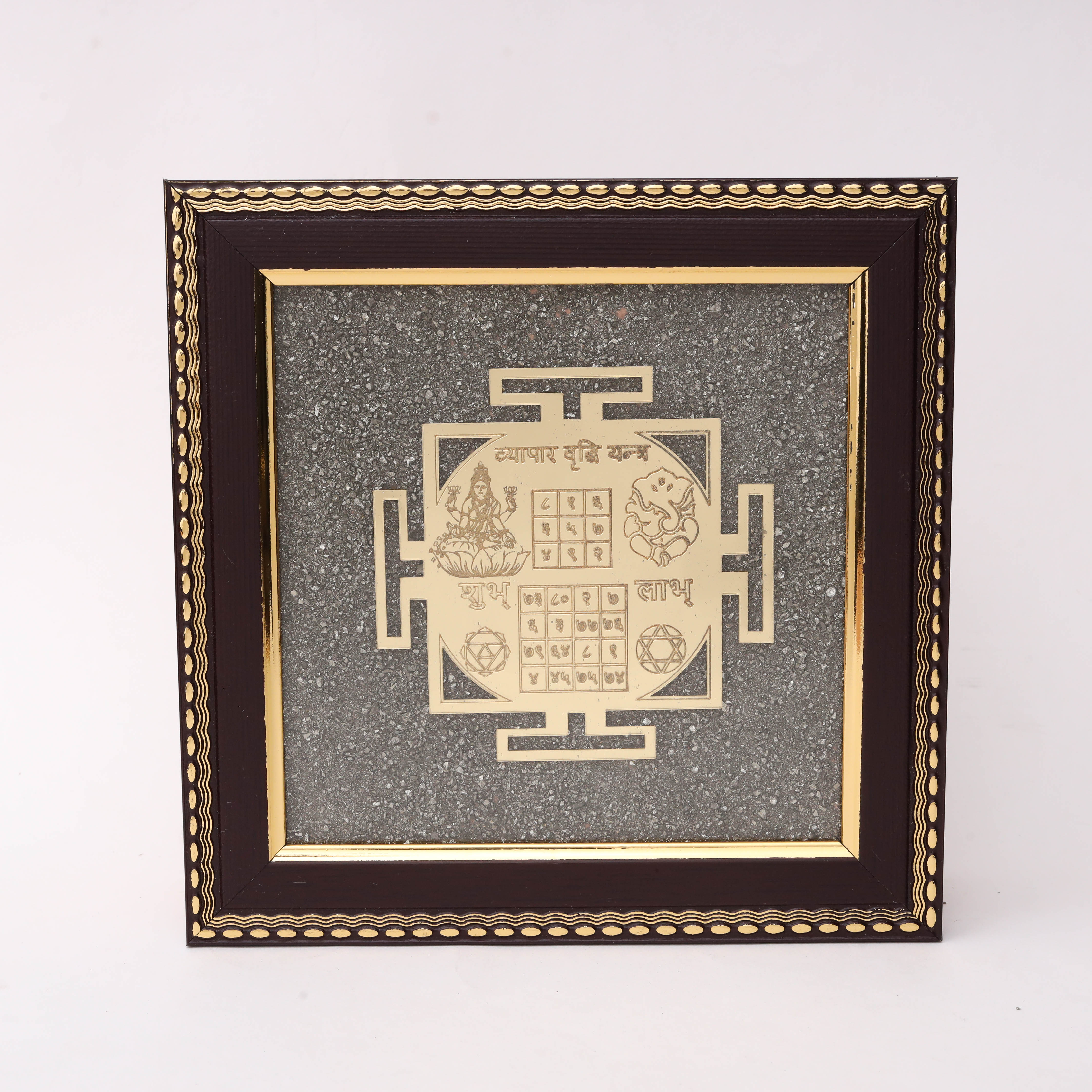 Gold laser-cut Vyapar Vridhi Yantra with Lakshmi Ganesh Shubh Labh numerical grids and Shatkona motif on charcoal stone texture background in dark wood decorative frame--1