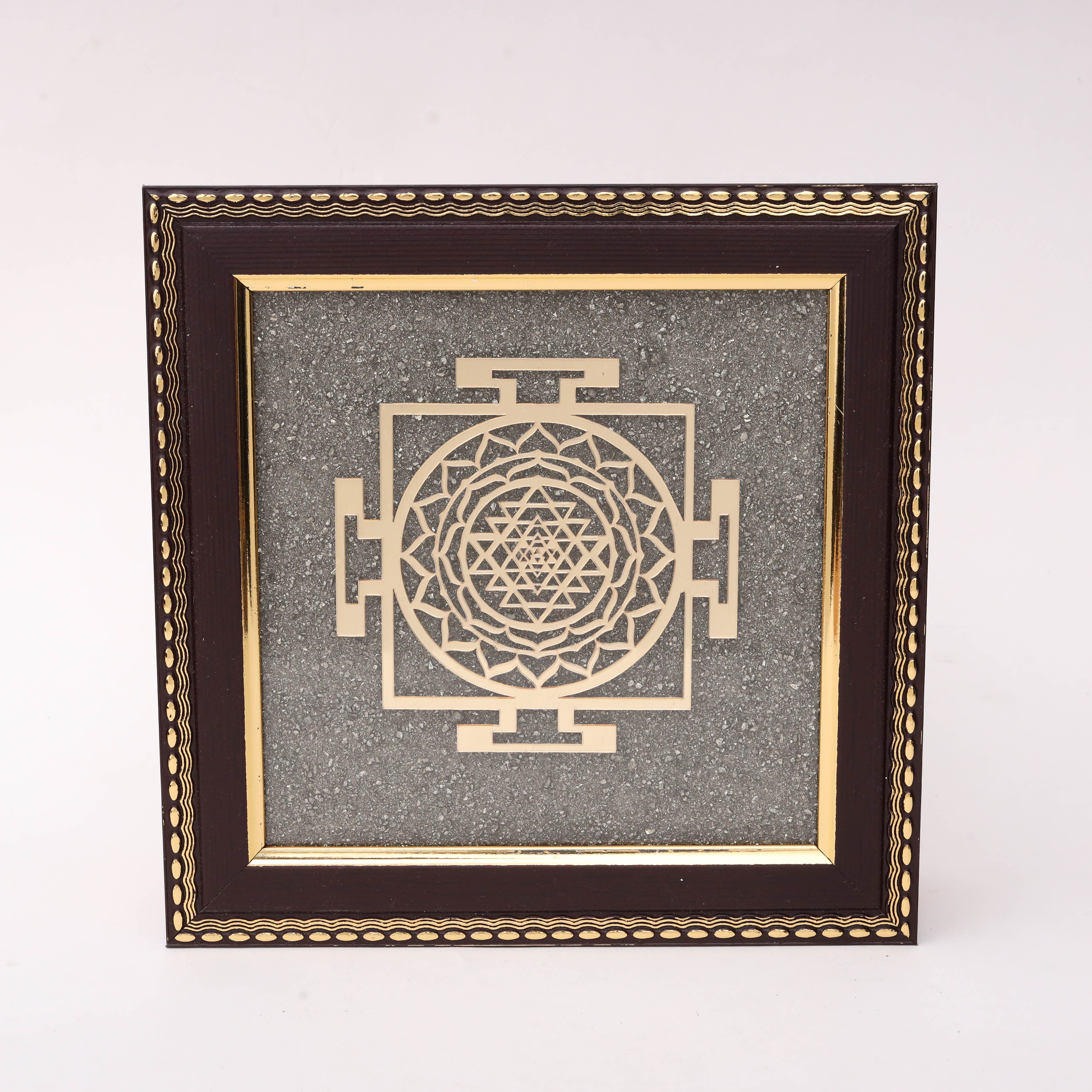 AstroViz Sri Yantra gold-tone laser-cut motif on grey stone chip background in dark brown ornate embossed wooden frame--1