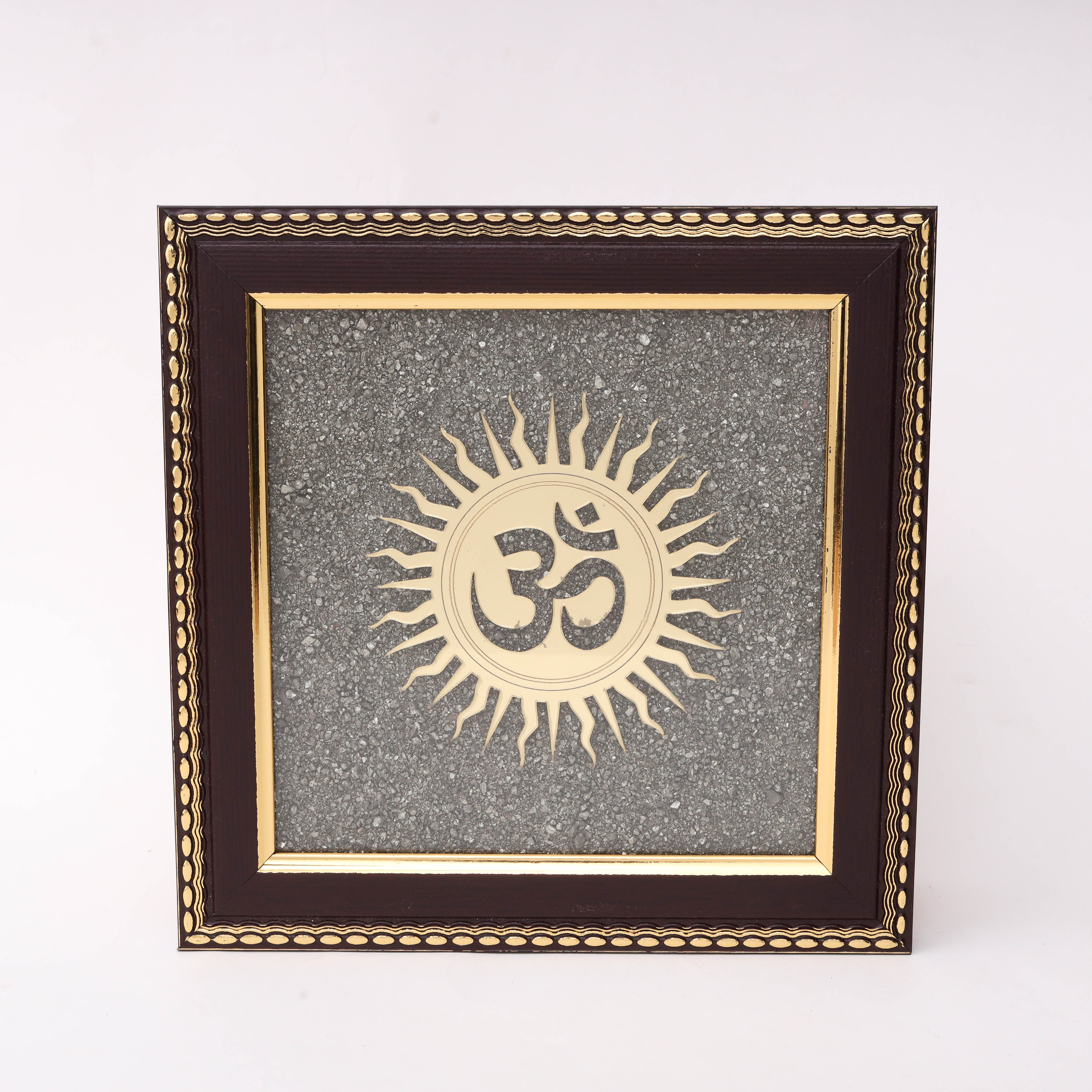 AstroViz Ganesha and Lakshmi gold-tone laser-cut motif on textured grey stone chip background in dark brown ornate wooden frame.
--1