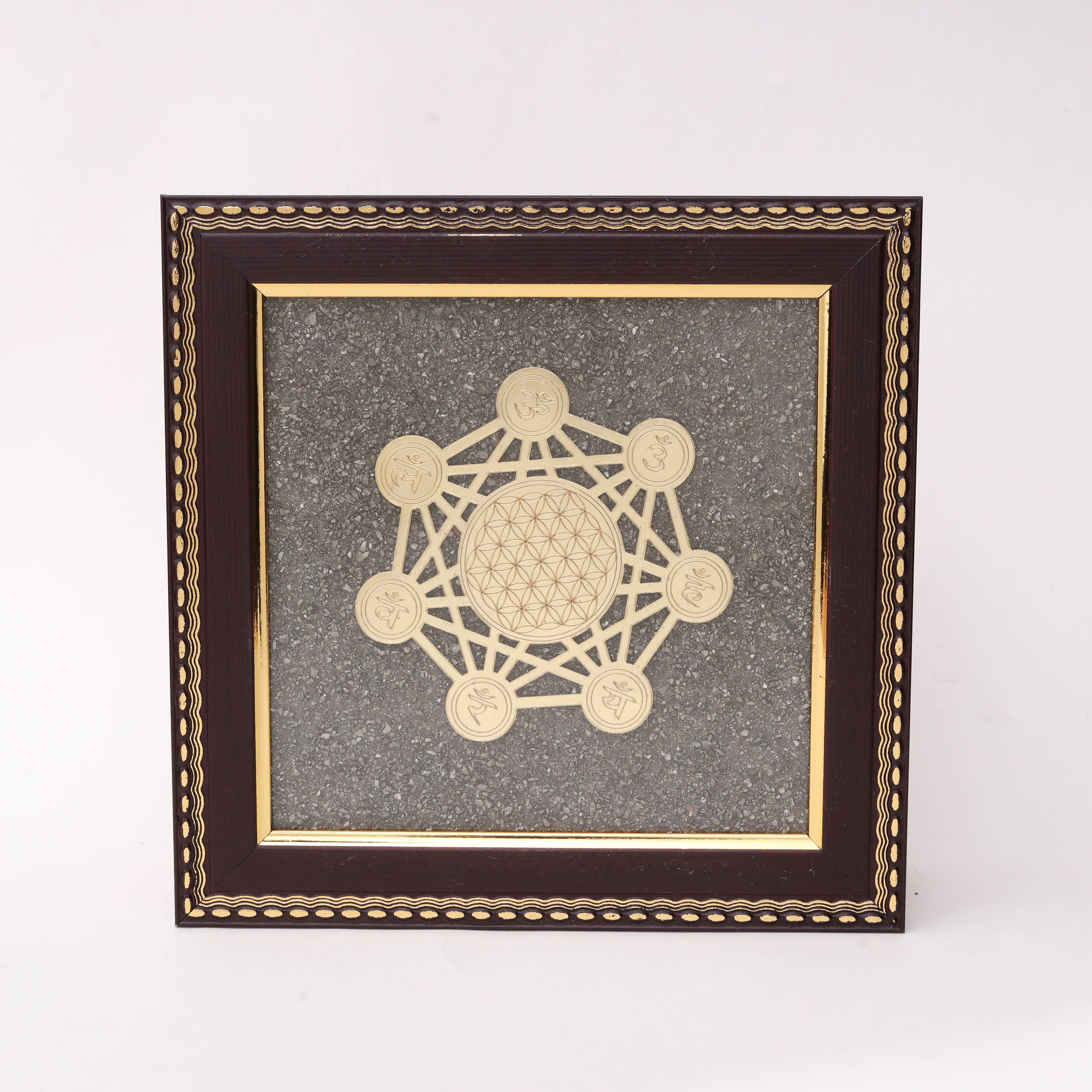 Gold laser-cut Metatron's Cube sacred geometry with Flower of Life center and seven Sanskrit symbol medallions on charcoal stone texture background in dark wood decorative frame--1